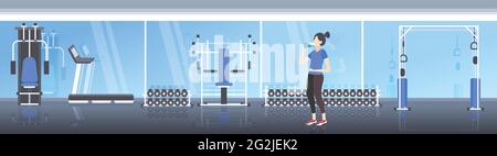 beautiful fitness athlete woman drinking water from plastic bottle after workout exercising healthy lifestyle concept modern gym interior horizontal Stock Vector