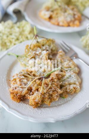 Sweet home made fried elderflowers in pancake on a table Stock Photo