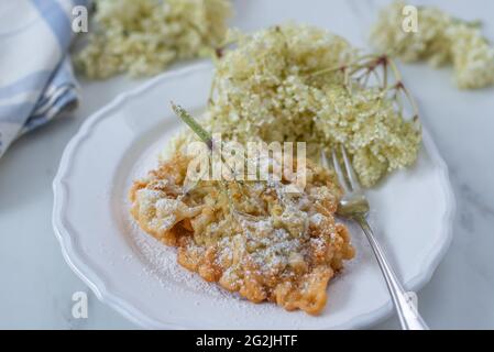 Sweet home made fried elderflowers in pancake on a table Stock Photo