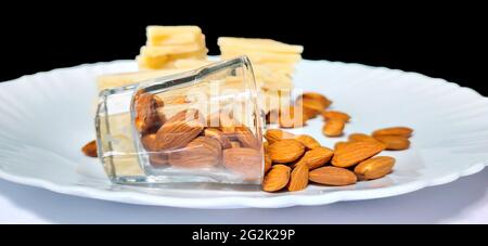 Badam Katli is a Diamond shape Indian sweet with almonds made using almonds, sugar and mava, served in a plate isolated on white background. selective Stock Photo