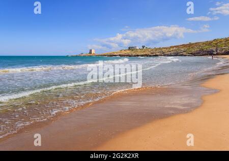 The most beautiful beaches of Apulia in Italy. Gusmay beach, framed by two spectacular roky peaks, is surrounded by the Mediterranean scrub. Stock Photo