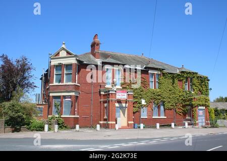 View of the front of the Golden Ball, a pub in Pilling, Lancashire, England that has been closed and boarded up with shutters and keep out signs. Stock Photo