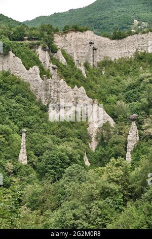 Pyramids of Zone Rock formations, also known as fairy chimneys, earth pyramids, hoodoos Monument rocks (Chalk Pyramids) of Zone at (ISEO) lake Lombard Stock Photo
