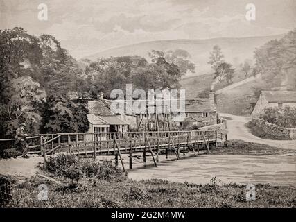 A late 19th century view of cottages near an old footbridge across the River Wye in Monsal Dale, a valley in the White Peak limestone area of the Peak District, Derbyshire, England, Stock Photo