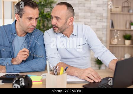 two men analyzing stats financial data Stock Photo