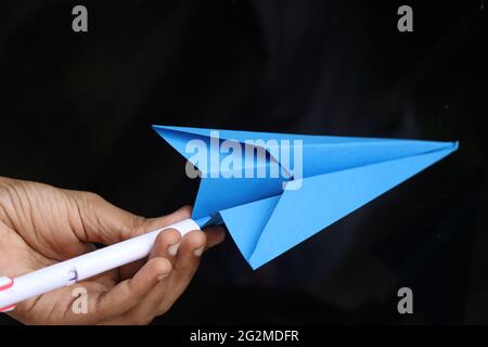 Origami paper airplane hand held. Paper crafts concept Stock Photo