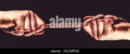 Rope, cord. Hand holding a rope, climbing rope, strength and determination Stock Photo