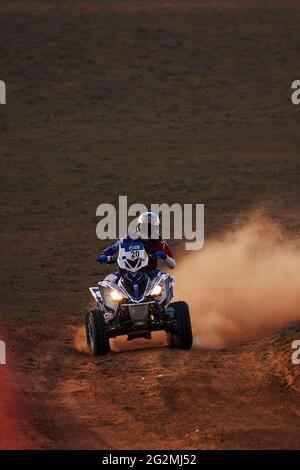 Quad Bike for Off Road Extreme Racing gets over the difficult part of the route during the Rally raid in sand. THE GOLD OF KAGAN-2021. 25.04.2021 Stock Photo