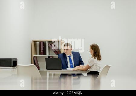 Businesspeople co-working comparing a desktop computer information with paper document at office. Stock Photo