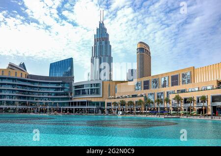 Dubai, United Arab Emirates - May 16, 2018: Towers and the Dubai Mall seen from the lake of Emaar square Stock Photo