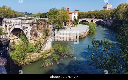 Rome, Italy.  Isola Tiberina or Tiber Island seen from Ponte Paletino The ruined single span is of the so-called Ponte Rotto, or Broken Bridge, which Stock Photo