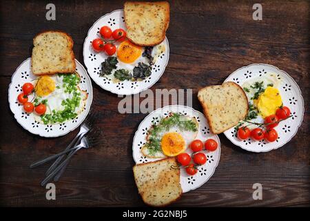 Healthy breakfast . Freshly made, delicious meal of eggs and vegetables. Fried eggs with herbs, leek, onion, kale, dill Stock Photo