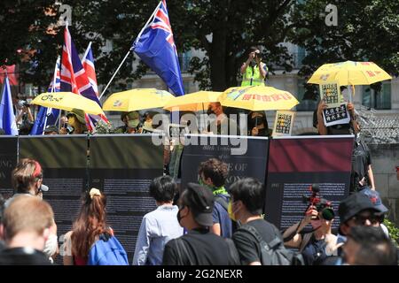 Pro-democracy activists hold placards and yellow umbrellas during a rally to mark the second anniversary of the massive pro-democracy protests which roiled Hong Kong in 2019. Stock Photo