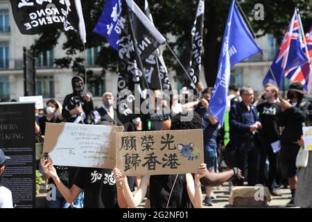 Pro-democracy activists hold placards  and flags during a rally to mark the second anniversary of the massive pro-democracy protests which roiled Hong Kong in 2019. Stock Photo