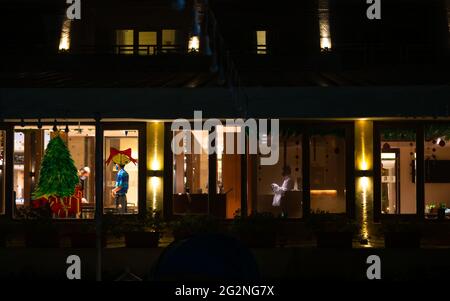 MUMBAI, INDIA - December 31, 2021: View of Hotel restaurant with staff operating. Glass painted with Christmas decoration. Stock Photo