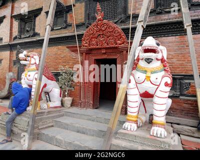 Nepali worker people renovate repair build scaffolding structure at ancient ruin antique building of Royal Kumari Ghar Palace or Temple House of the L Stock Photo