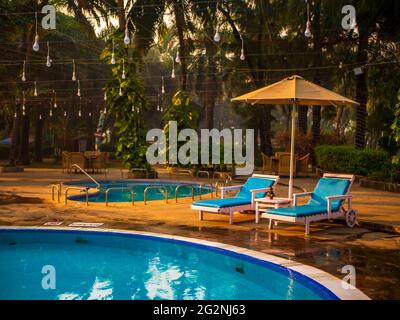 MUMBAI, INDIA - December 31, 2021: Beautifully decorated chair around the outdoor swimming pool in hotel and resort Stock Photo