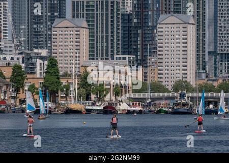 London, UK. 12th June, 2021. UK Weather: Paddle boarders enjoy a cooler river breeze on Greenland Dock, Swedish Quay as the weekend heatwave sees temperatures soar 25-30C in parts of the city and south east. Credit: Guy Corbishley/Alamy Live News Stock Photo