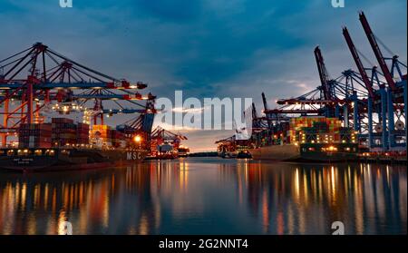 Huge loading cranes in the port of Hamburg by night - CITY OF HAMBURG, GERMANY - MAY 10, 2021 Stock Photo