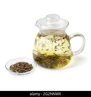 Glass teapot with a mixture of healthy herbal tea as a hot drink isolated on white background Stock Photo