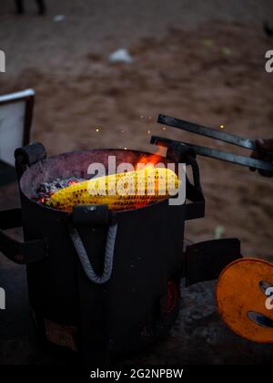 Sweet corn on Charcoal with Selective focusing. Delicious Snacks. Sweetcorn cobs grilled. Popular street food in India. Stock Photo