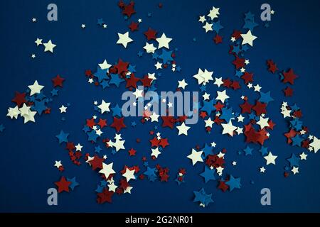 4th of July American Independence Day stars decorations on blue background. Flat lay, top view. Stock Photo