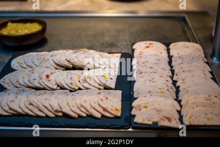 Beautifully decorated slices of Chicken Salami. Preparation for the banquet. Buffet, serving. Stock Photo