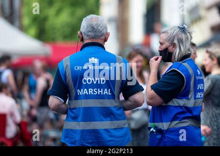 London, UK. 12 June 2021.  City of Westminster Covid Marshals on patrol in Soho.  Scientific advisers to the UK government have called for a delay to the complete lifting of coronavirus lockdown restrictions on 21 June, possibly by four weeks, to allow scientists to assess the link between rising numbers of Covid-19 cases (mainly the newly identified Delta variant) and hospital admissions.  Credit: Stephen Chung / Alamy Live News Stock Photo