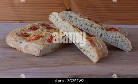 Italian bread called foccacia stuffing with cheese ham herbs and tomato Stock Photo