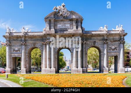 East side. The Puerta de Alcalá is one of the five old royal gates that gave access to the city of Madrid, is a Neo-classical gate in the Plaza de la Stock Photo