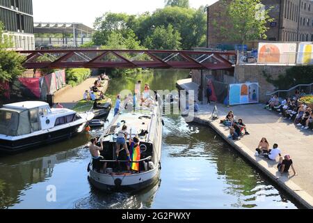 London, UK, June 12th 2021. Party goers celebrating Pride month boat down the Regents Canal past Granary Square at Kings Cross. Monica Wells/Alamy Live News Stock Photo