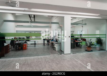A modern glass office in the industry. Office with computers, tablets and modern devices. Stock Photo