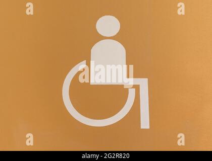 White and yellow sign painted on floor of an underground parking lot - places for disabled people. Stock Photo