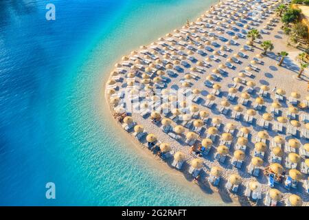Aerial view of sea, empty sandy beach with sunbeds and umbrellas Stock Photo