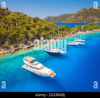 Aerial view of beautiful yachts, boats on the sea bay at sunset Stock Photo