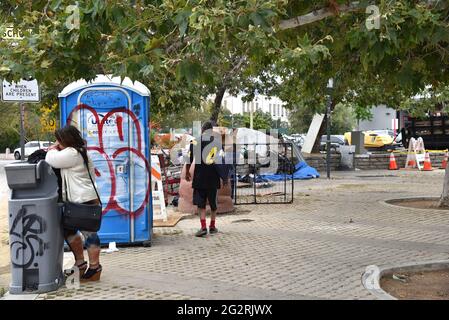 Los Angeles, CA USA - May 26 , 2021: Homeless people at portable restrooms on the east entrance to Hollywood Boulevard Stock Photo