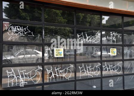 Los Angeles, CA USA - September 13, 2020: Black lives matter signs and graffiti cover windows of a retail business that couldn't reopen after long loc Stock Photo