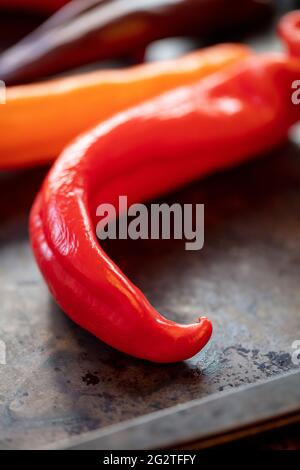 Colorul Poivron peppers being prepped on a wood table for roasting in the oven Stock Photo