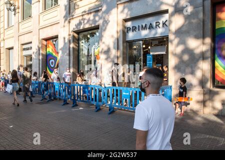 Barcelona, Spain. 12th June, 2021. Queue of people seen at clothing store entrance, Primark.With the arrival of summer and the opening to tourists in Spain, the beaches and the center of Barcelona, the city begins to return to normality from the summers before the coronavirus pandemic. Credit: SOPA Images Limited/Alamy Live News Stock Photo