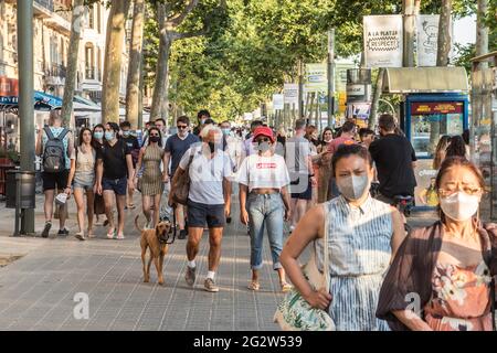Barcelona, Spain. 12th June, 2021. People are seen in the Barceloneta neighborhood in Barcelona.With the arrival of summer and the opening to tourists in Spain, the beaches and the center of Barcelona, the city begins to return to normality from the summers before the coronavirus pandemic. Credit: SOPA Images Limited/Alamy Live News Stock Photo