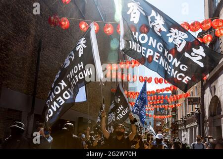 Protestors wave flags saying Hong Kong independence during the demonstration.On June 12th 2019, protestors in Hong Kong took to the streets calling for the retraction of the China extradition bill, but were met with brutal police force. Led by Hong Kong Liberty, the Hong Kong diaspora in London gathered and marched in remembrance of the 2019 protest, expressing solidarity with freedom fighters in Hong Kong against political oppression by the Chinese Communist Party. The march started from Marble Arch, went through Oxford Circus and China Town, and eventually ended at Trafalgar Square. (Photo b Stock Photo