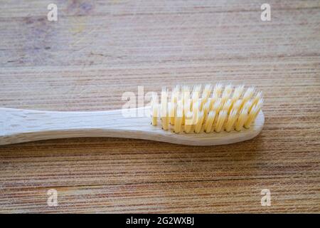 Toothbrush made of bamboo on a wooden background Stock Photo