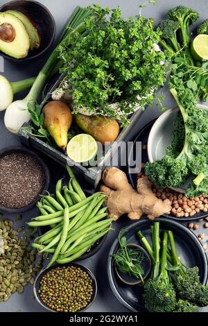 Assorted green vegetables and cereal on gray background. Healthy food ...