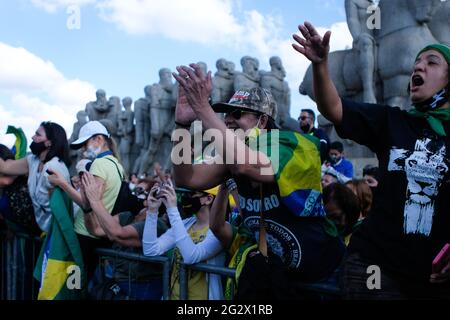 Sao Paulo, Brazil. 12th June, 2021. Supporters of Brazilian President Bolsonaro cheer during a motorcycle rally in the metropolis of São Paulo. Because Bolsonaro was again without a mask, he was fined by the state government of a political opponent. Credit: Lincon Zarbietti/dpa/Alamy Live News Stock Photo