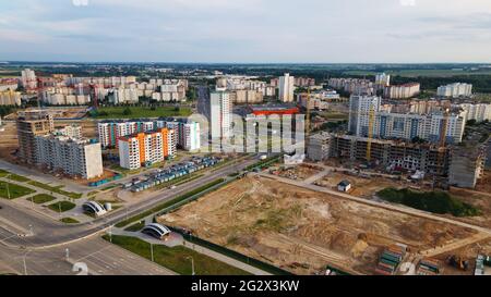 Aerial view of the new urban development. New houses are being built. The cranes are visible. Stock Photo