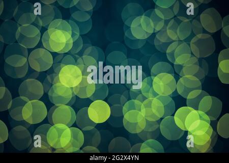 Green background with natural bokeh defocused sparkling lights. Magical shiny abstract background. Stock Photo