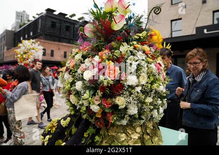 New York, USA. 12th June, 2021. People enjoy themselves during a flower festival in New York, the United States, June 12, 2021. The event which kicked off on Saturday features flower sales and display of floral installations. Credit: Wang Ying/Xinhua/Alamy Live News Stock Photo