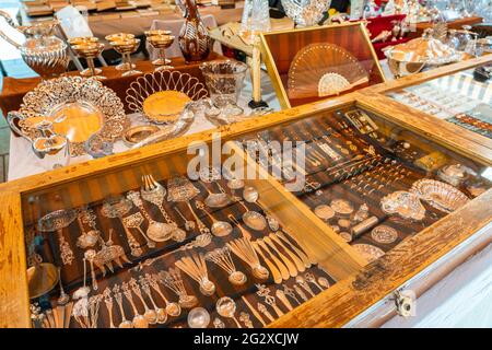 BARCELONA, SPAIN - JUNE 10, 2019: Antique objects, coins, jewels, tableware and other utensils at a flea market Stock Photo