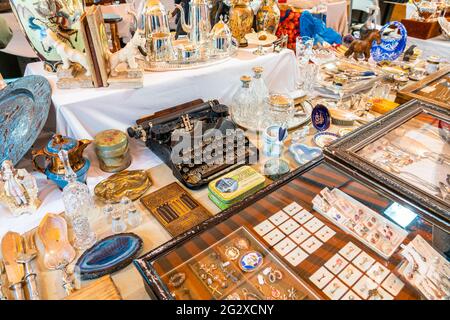 BARCELONA, SPAIN - JUNE 10, 2019: Antique objects, coins, jewels, tableware and other utensils at a flea market Stock Photo