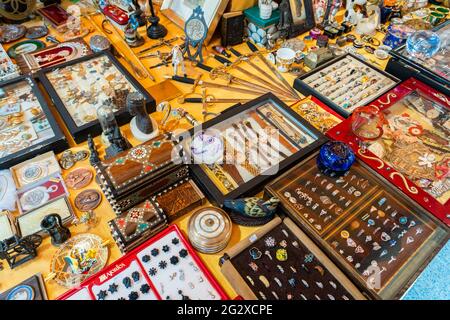 BARCELONA, SPAIN - JUNE 10, 2019: Antique objects, coins, jewels, tableware and other utensils at a flea market Stock Photo